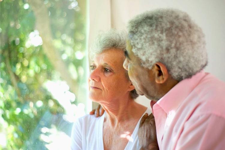 If you need residential care your council could claw back the cost - older couple looking out of a windows